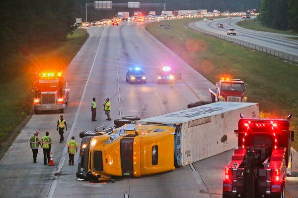 The northbound lanes of I-675 in Clayton County are blocked by an overturned tractor-trailer in June 2014. The rate of commercial vehicle crashes has been spiking in Georgia since 2011, an analysis of crash data by the AJC found. Yet Georgia did 20 percent fewer truck inspections from 2011 to 2014, and removed 30 percent fewer trucks and drivers from the road for violations, according to federal data. JOHN SPINK/JSPINK@AJC.COM