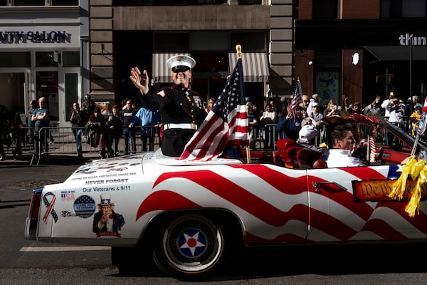 Grand Marshal Dakota Meyer, U.S. Marine Corps, (Medal of Honor Recipient) waves from a car during the annual Veterans Day Parade, Monday, Nov. 11, 2024, in New York. (AP Photo/Adam Gray)