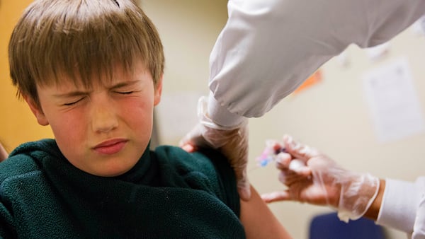 Reed Olson, 8, gets a flu shot at a Dekalb County health center in Decatur, Ga., Monday, Feb. 5, 2018. The U.S. government's latest flu report released on Friday, Feb. 2, 2018, showed flu season continued to intensify the previous week, with high volumes of flu-related patient traffic in 42 states, up from 39 the week before. (AP Photo/David Goldman)