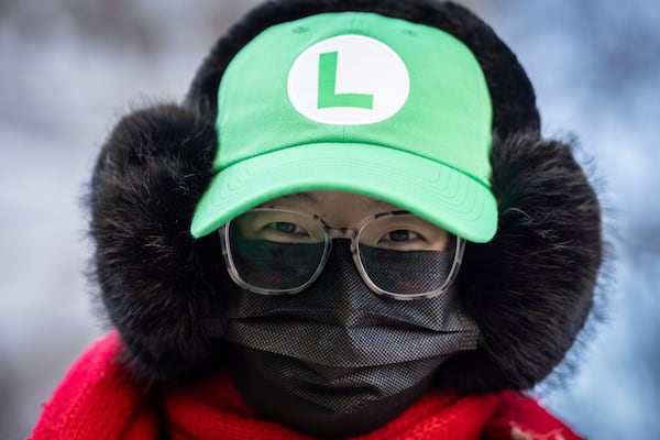 A supporter Luigi Mangione wears a Nintendo character's green Luigi hat outside court, Friday, Feb. 21, 2025 in New York. (AP Photo/Stefan Jeremiah)