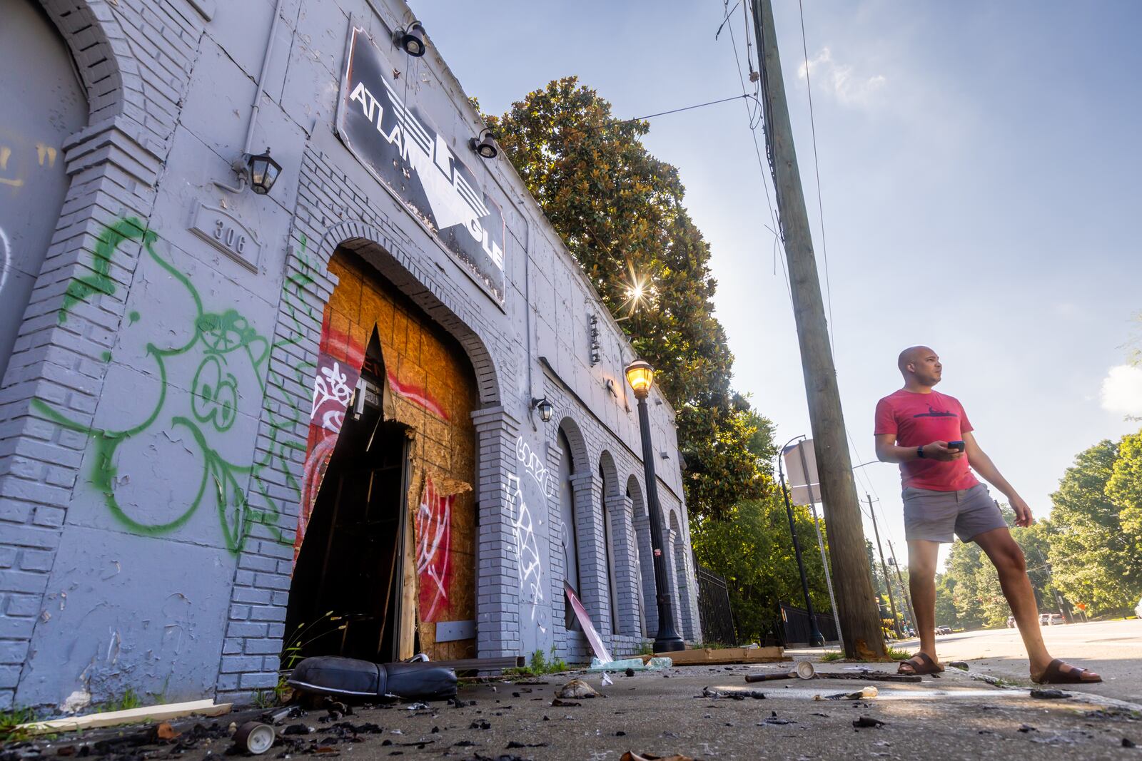 City of Atlanta Director of LGBTQ Affairs Malik Brown surveys fire damage at the Atlanta Eagle's former location on Ponce de Leon Avenue in June. (John Spink/AJC)