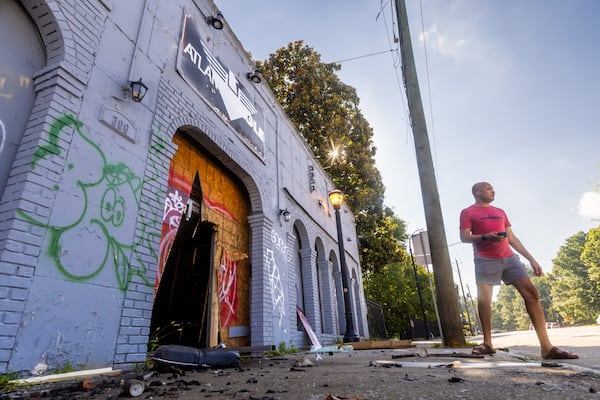 City of Atlanta Director of LGBTQ Affairs Malik Brown surveys fire damage at the Atlanta Eagle's former location on Ponce de Leon Avenue in June. (John Spink/AJC)