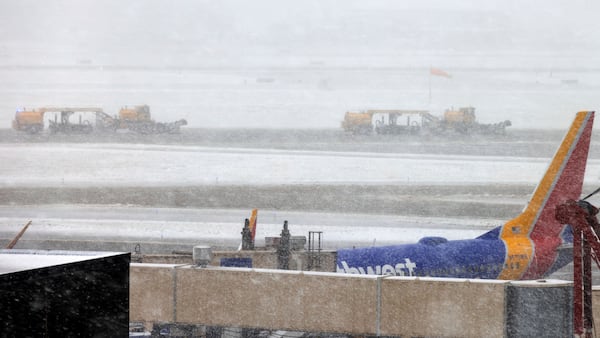 Trucks clear snow at Eppley Airfield during a blizzard in Omaha, Neb. on Wednesday, March 19, 2025. (Chris Machian/Omaha World-Herald via AP)