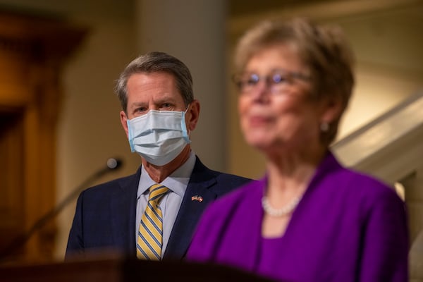 Gov. Brian Kemp listens as Dr. Kathleen Toomey, Commissioner of Georgia Department of Public Health, gives remarks during a COVID-19 update press conference at the Georgia State Capitol Building in Atlanta on Jan. 21. (Alyssa Pointer / Alyssa.Pointer@ajc.com)