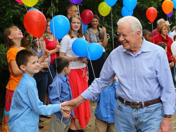 Former President Jimmy Carter greets visitors at his surprise 90th birthday party in Plains. He turns 100 in October.