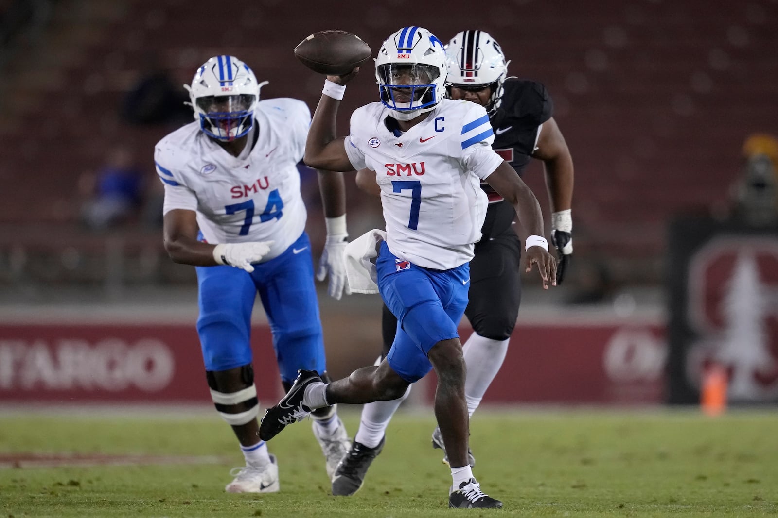 SMU quarterback Kevin Jennings (7) passes against Stanford during the second half of an NCAA college football game in Stanford, Calif., Saturday, Oct. 19, 2024. (AP Photo/Jeff Chiu)