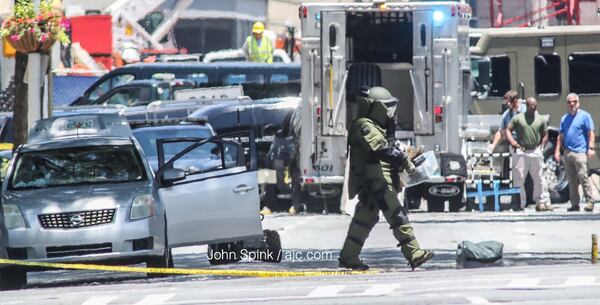 A bomb tech empties a car of all its contents, hours after a disgruntled Air Force veteran set himself on fire Tuesday morning outside the Georgia Capitol. JOHN SPINK / JSPINK@AJC.COM