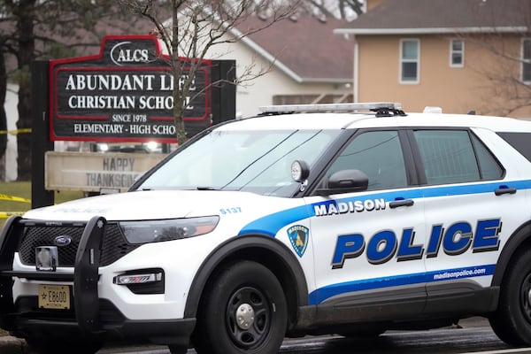 Emergency vehicles are parked outside the Abundant Life Christian School in Madison, Wis., where multiple injuries were reported following a shooting, Monday, Dec. 16, 2024. (AP Photo/Morry Gash)