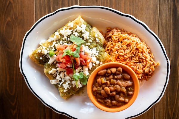 Dos Bocas Enchilada Verde, three chicken enchiladas, salsa verde, sour cream, queso cotija, pico de gallo, served with rice and charro beans. Photo credit- Mia Yakel.