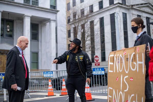 Devin Harrington-Ward of the Movement for Black Lives, center, speaks with Pete Skandalakis outside the Georgia Capitol during a protest over voting legislation moving through the General Assembly. (Alyssa Pointer / Alyssa.Pointer@ajc.com)