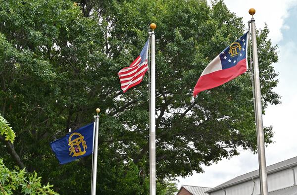 June 16, 2020 Kennesaw - The Confederate battle flag was removed and replaced it with the original Georgia state flag (left) that was flown during the Civil War at the city's war memorial in downtown Kennesaw on Tuesday, June 16, 2020. The Kennesaw City Council voted Monday to remove the Confederate battle flag from its war memorial and replace it with the original Georgia state flag that was flown during the Civil War. (Hyosub Shin / Hyosub.Shin@ajc.com)