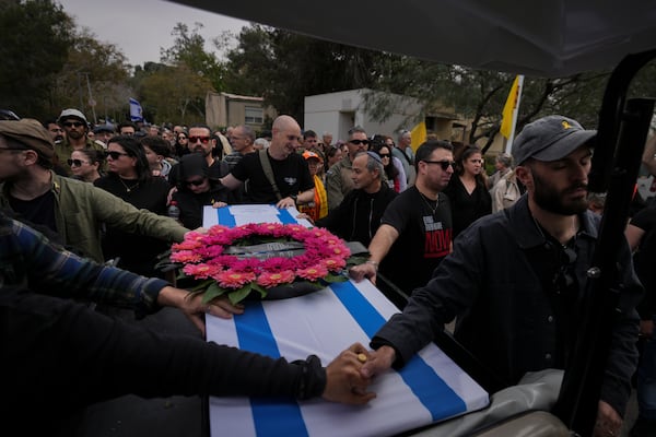 Mourners carry the coffin of Itzhak Elgarat, a slain hostage who was held captive by Hamas in Gaza, during his funeral procession in Kibbutz Nir Oz, Israel, on Monday, March 3, 2025. (AP Photo/Ohad Zwigenberg)