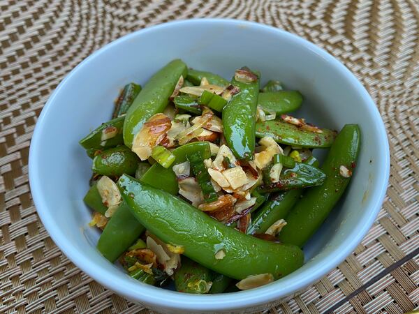 The sugar snap peas on the menu at Tiny Lou's are a springtime play on green beans amandine. Ligaya Figueras/ligaya.figueras@ajc.com