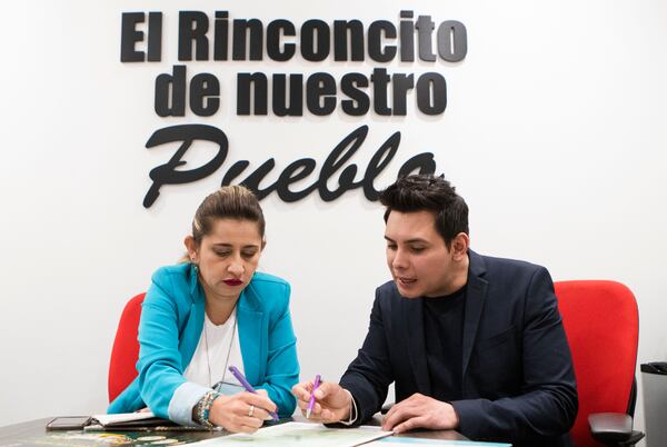 Plaza Fiesta property manager Cristina Bolanos (left) and marketing director Gio Garcia discuss an upcoming event at Plaza Fiesta. CHRISTINA MATACOTTA FOR THE ATLANTA JOURNAL-CONSTITUTION.