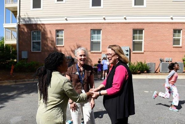 Rainbow Village Community Engagement Director Michelle Alcorn introduces a volunteer to Deacon Nancy Yancey at the 2017 Rainbow Village end of school year event. Yancey, executive director of the nonprofit, is planning to retire at the end of the year. CONTRIBUTED