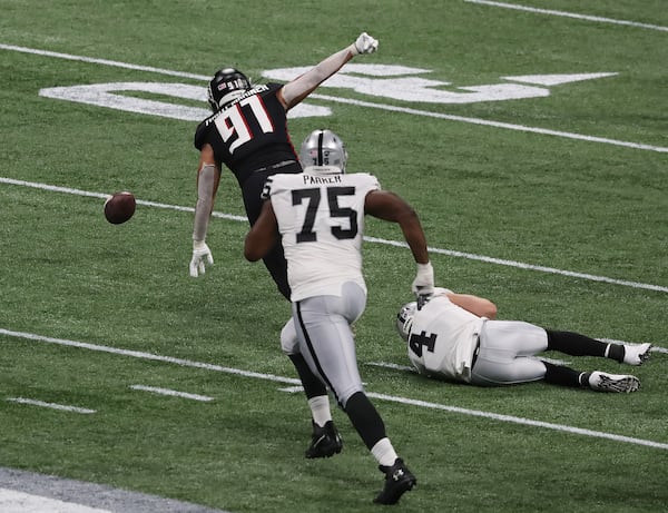 Falcons defensive tackle Jacob Tuioti-Mariner strip sacks Las Vegas Raiders quarterback Derek Carr and recovers the fumble during the second quarter Sunday, Nov. 29, 2020, at Mercedes-Benz Stadium in Atlanta. (Curtis Compton / Curtis.Compton@ajc.com)