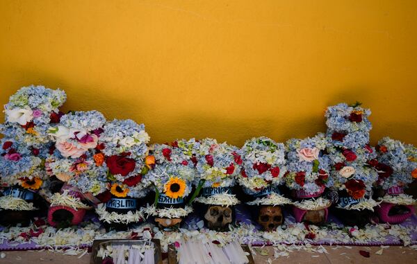 Decorated human skulls lay on the ground at the General Cemetery as part of the annual “Ñatitas” festival, a tradition marking the end of the Catholic holiday of All Saints, in La Paz, Bolivia, Friday, Nov. 8, 2024. (AP Photo/Juan Karita)