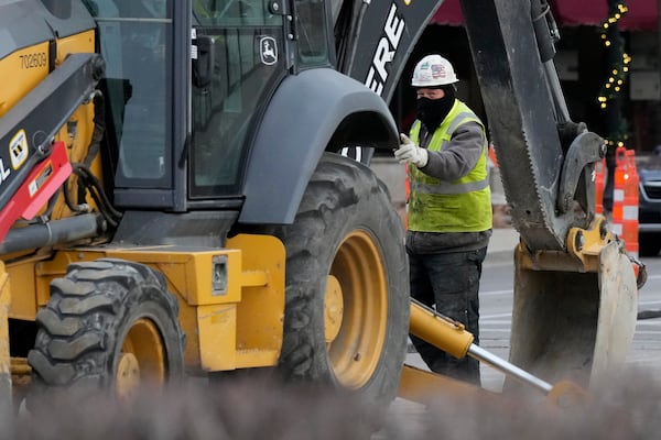 A construction worker bundles up as he works during cold weather in Northbrook, Ill., Thursday, Dec. 12, 2024. (AP Photo/Nam Y. Huh)