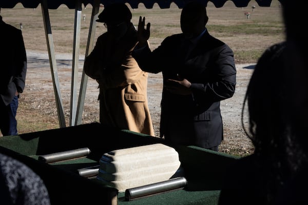 Bishop Donald Bolton prays over the casket of Maëlla Hope Makongote, who was born and died on Dec. 18, at a service conducted by the Fulton County indigent burial program at Lakeside Cemetery in Palmetto on Thursday, Dec. 28, 2023. (Arvin Temkar / arvin.temkar@ajc.com)