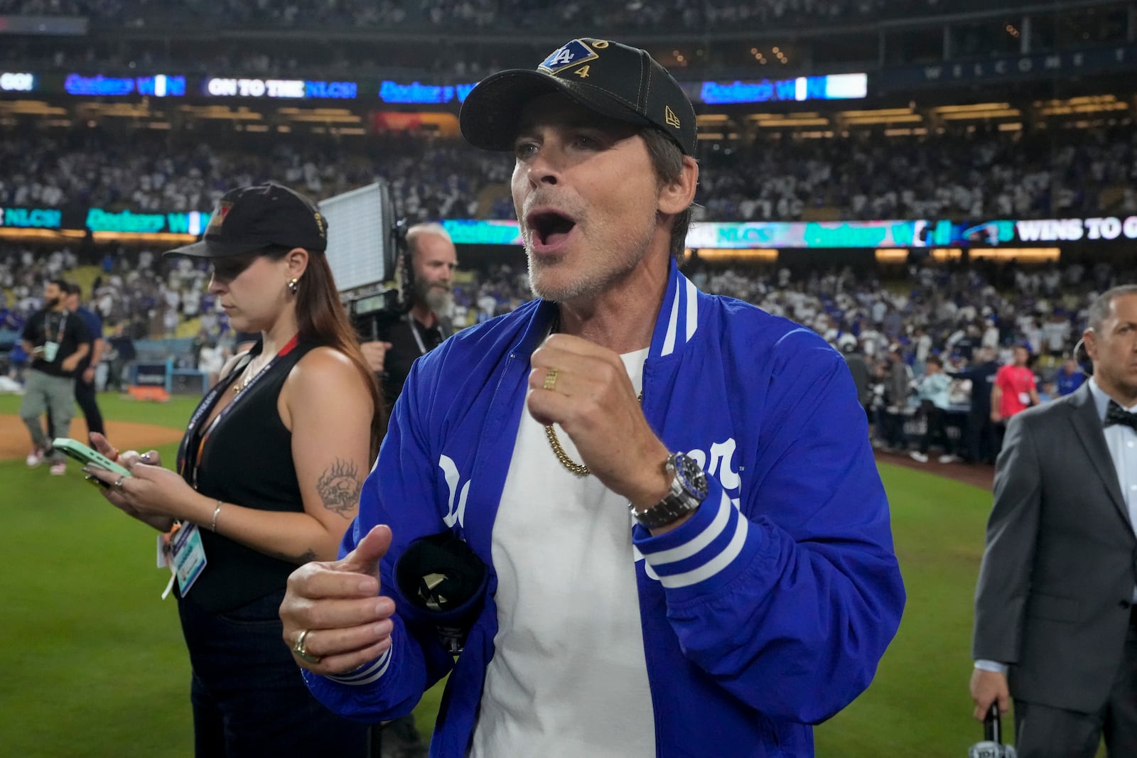 Actor Rob Lowe celebrates on the field after the Los Angeles Dodgers beat the San Diego Padres in Game 5 of a baseball NL Division Series Friday, Oct. 11, 2024, in Los Angeles. (AP Photo/Mark J. Terrill)