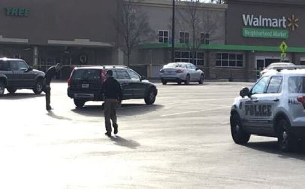 Officers converge on a shopping center in Dunwoody in search of an armed robbery suspect. The man was shot by an officer and later died.