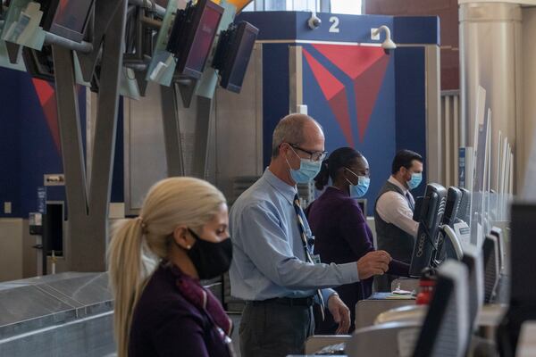 Delta Air Lines employees work the ticket counter in the domestic terminal at Hartsfield-Jackson International Airport in Atlanta on Friday, September 4, 2020. (Alyssa Pointer / Alyssa.Pointer@ajc.com)