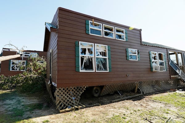 Smashed windows and blown off roofs are the remnants of some cabins at Paradise Ranch RV Resort that were damaged from a series of storms that passed the area in Tylertown, Miss., Sunday, March 16, 2025. (AP Photo/Rogelio V. Solis)