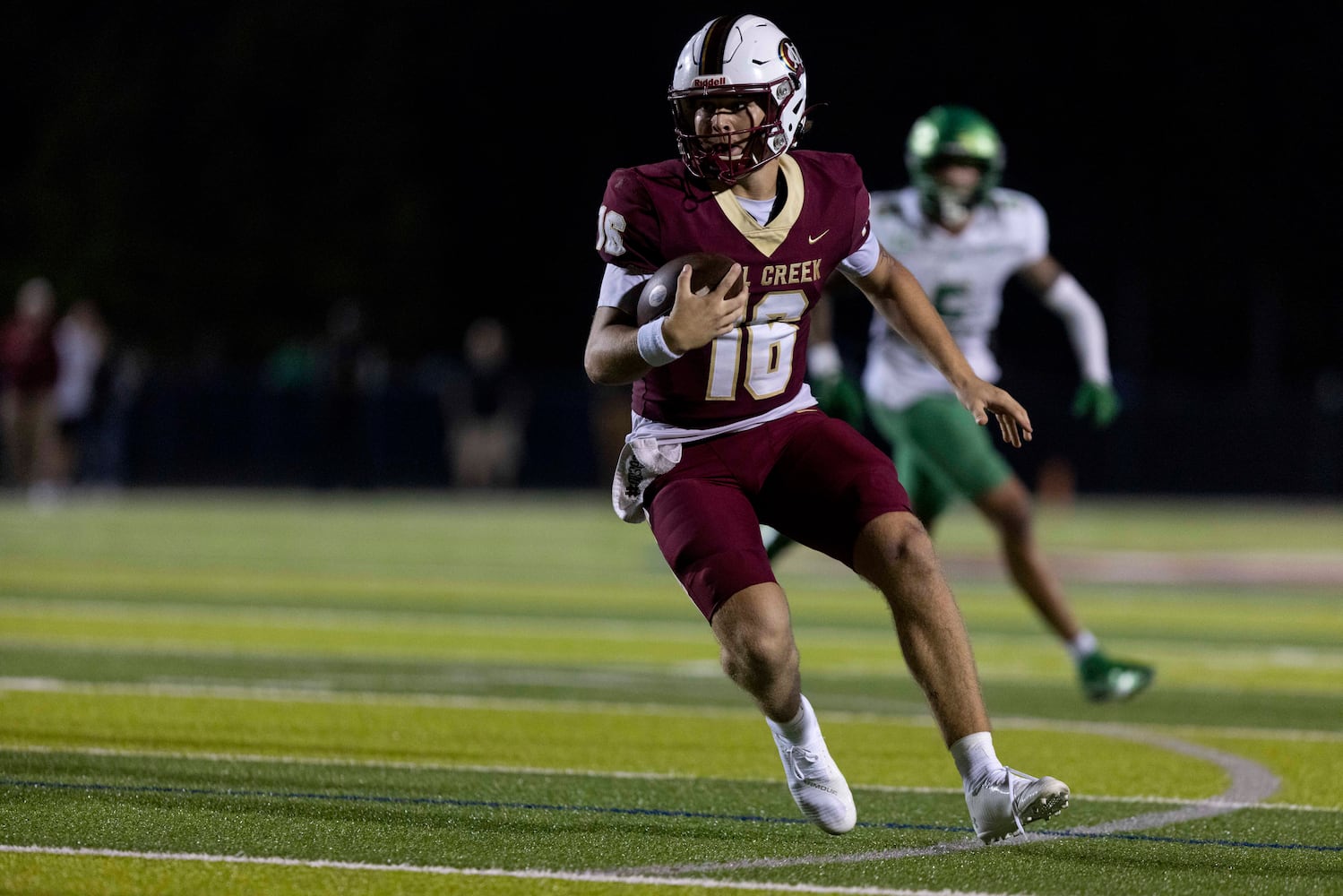 Mill Creek quarterback Nathan Kava (16) runs the ball. (Photo/Jenn Finch, AJC)