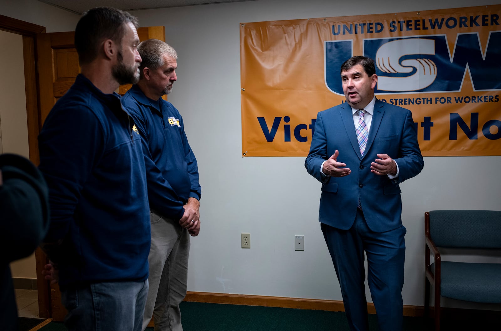 From left, Cary Eldridge, United Steelworkers (USW) Sub District Director, Syracuse office, and Jack Vanderbaan USW Staff, Syracuse, listen as New York State Senator John Mannion, Democratic candidate for New York's 22nd congressional district, meets with representatives and members of the United Steelworkers in Geddes, N.Y. Thursday. Oct. 24. 2024. (AP Photo/Craig Ruttle)