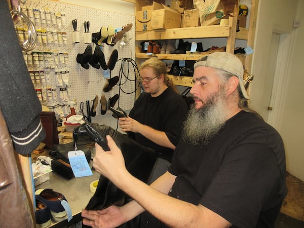 Ryan Embry’s son, Jackson Embry, left, and his oldest apprentice Stewart Korab work hard making boots look as good as new — if not better.
Courtesy of Ryan Embry