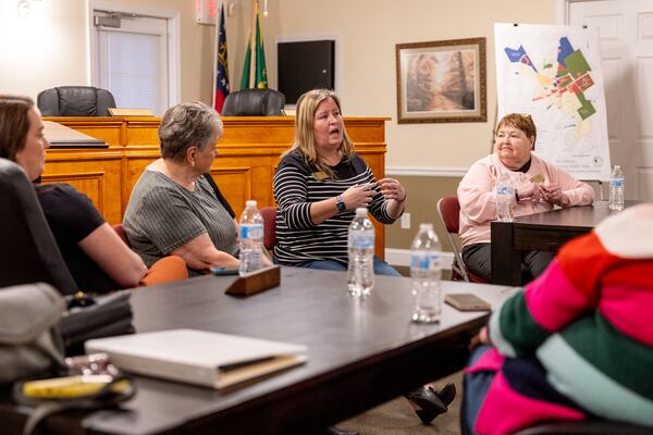 City council member Rachel Davis (center) speaks to a reporter before a work session meeting at the city municipal building in Walnut Grove on Thursday, January 30, 2025. (Arvin Temkar / AJC)