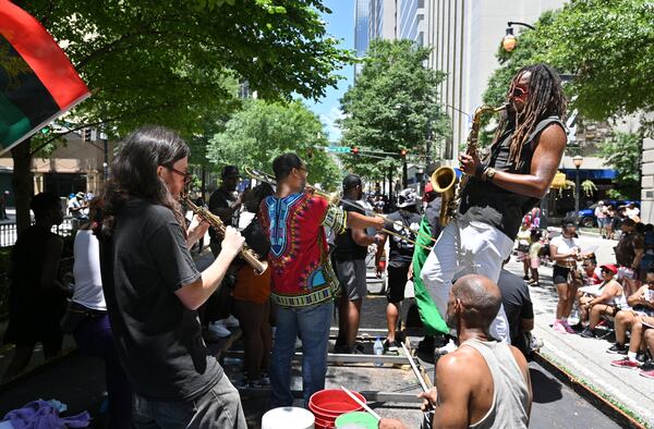 June 18, 2022 Atlanta - A float makes its way down on Marietta street during the Juneteenth Atlanta Black History Parade on Saturday, June 18, 2022. The 10th annual Juneteenth Atlanta Parade & Music Festival is a four-day free music festival that also includes a black history parade. Juneteenth, a June 19 holiday, recognizes the last African American slaves being freed in 1865, more than two years after the Emancipation Proclamation was signed. Now a federal holiday, Juneteenth celebrates African American freedom, history, culture, achievements and more with a variety of commemorative events including history lessons, art, music and empowerment programs. (Hyosub Shin / Hyosub.Shin@ajc.com)