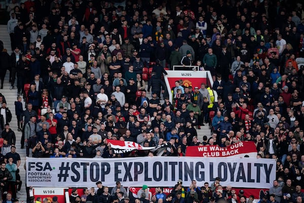 Manchester United's fans show a banner during the English Premier League soccer match between Manchester United and Everton at the Old Trafford stadium in Manchester, England, Sunday, Dec. 1, 2024. (AP Photo/Dave Thompson)