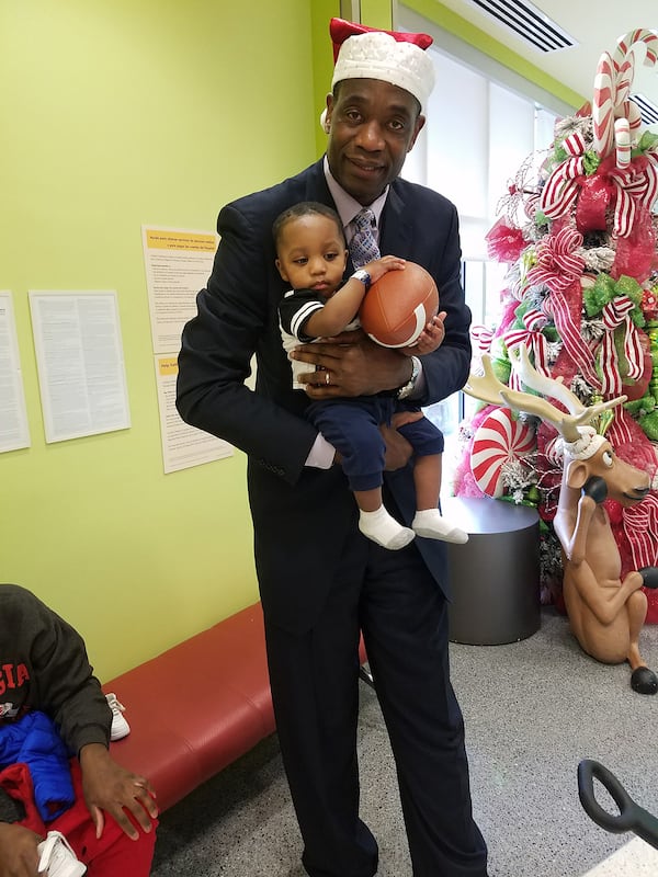 Mutombo with patients at Hughes Spalding Children's Hospital. CONTRIBUTED BY: Dikembe Mutombo Foundation