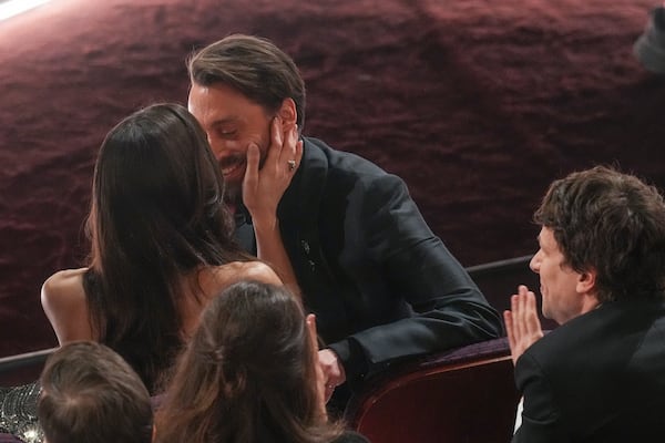 Jazz Charton, left, kisses Kieran Culkin as he wins the award for best performance by an actor in a supporting role for "A Real Pain" during the Oscars on Sunday, March 2, 2025, at the Dolby Theatre in Los Angeles. (AP Photo/Chris Pizzello)