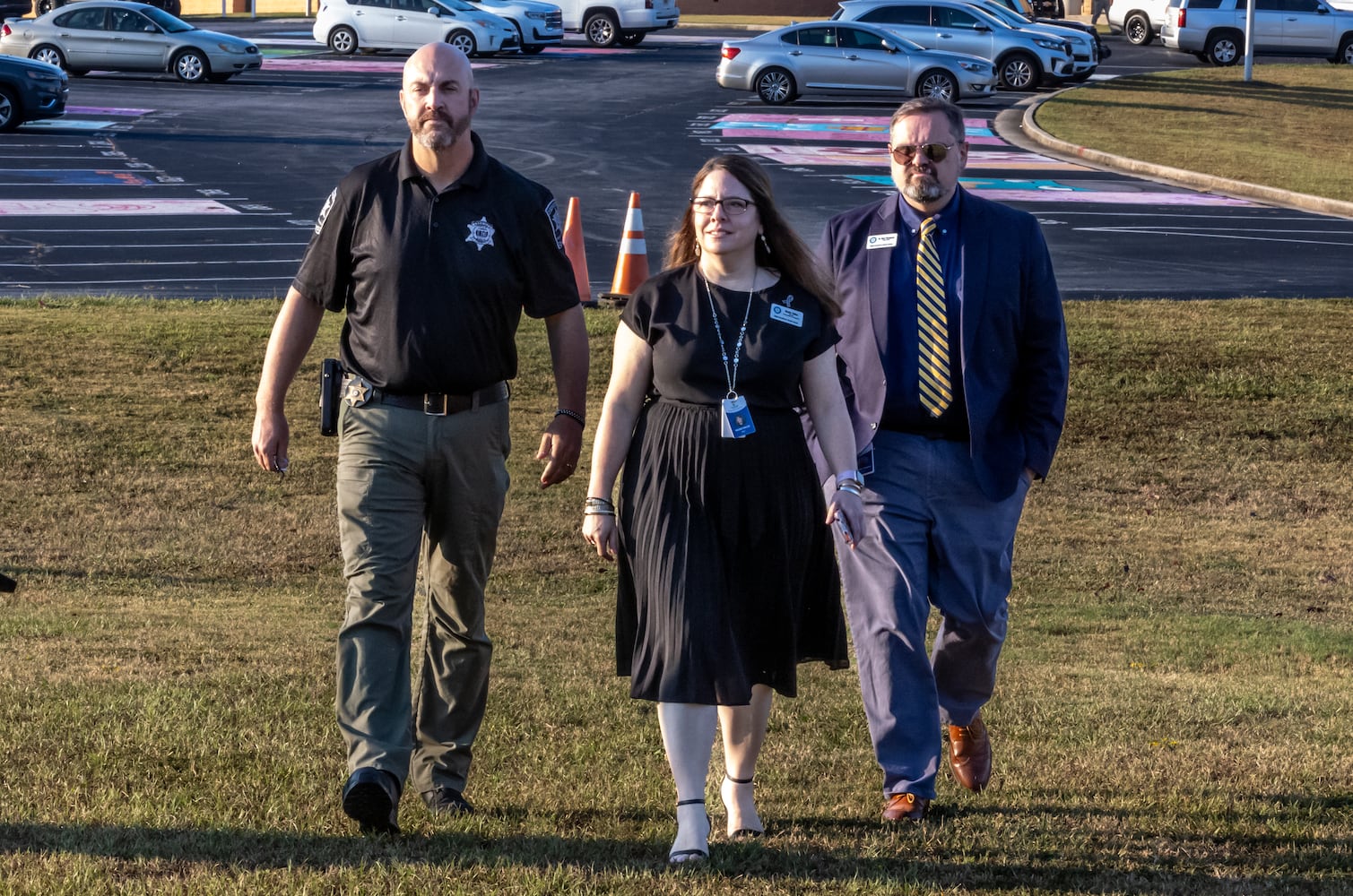 Barrow County sheriff Jud Smith (left) and Barrow County Schools Director of Communications and Engagement Nicole Valles (center) and Chief of Staff, Dr. Matt Thompson (right) walk to the morning press conference. Apalachee High School students returned to the Barrow County campus for the first time Monday, Sept. 23, 2024 after police say a 14-year-old student shot and killed four people at the school on Sept. 4. Barrow County Sheriff Jud Smith called the return “a huge step for us healing” in a briefing with reporters ahead of an open house for students. (John Spink/AJC)