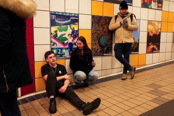 People take shelter in a metro station as a siren sounds a warning of incoming rockets from Lebanon in Haifa, Tuesday, Nov. 26, 2024. (AP Photo/Francisco Seco)