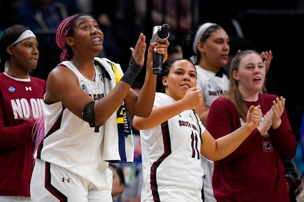 South Carolina's Aliyah Boston cheers from the bench in the final seconds of the second half of a college basketball game in the semifinal round of the Women's Final Four NCAA tournament Friday, April 1, 2022, in Minneapolis. (AP Photo/Charlie Neibergall)