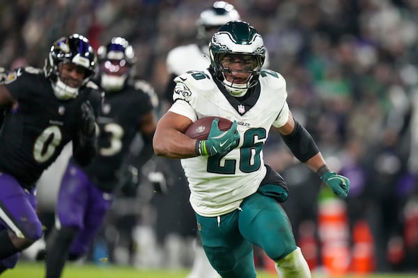 Philadelphia Eagles running back Saquon Barkley (26) runs with the ball against the Baltimore Ravens during the second half of an NFL football game, Sunday, Dec. 1, 2024, in Baltimore. (AP Photo/Stephanie Scarbrough)