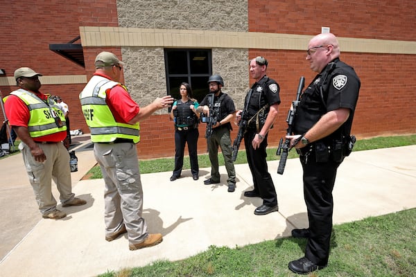 Cherokee County Sheriff’s Office conducts a training exercise at Mill Creek middle school Wednesday, June 8, 2022, in Woodstock, Ga. The training exercise was an active shooter drill to prepare officers to respond to school shootings. This training exercise was staged and students were volunteered to act during the exercise. (Jason Getz / Jason.Getz@ajc.com)