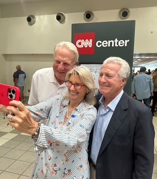 Teya Ryan (center) takes a selfies with fellow CNN alums Rick Davis (left) and Steve Korn (right) during the CNN legacy party June 1, 2023, to bid farewell to CNN Center. RODNEY HO/rho@ajc.com