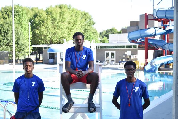 Brothers Nguaia De Jesus, 18, (right) and 16-year-old twins (from left) Zediwa and Nhenze De Jesus are lifeguards at the East Lake Family YMCA in Atlanta. Courtesy of William Herriott