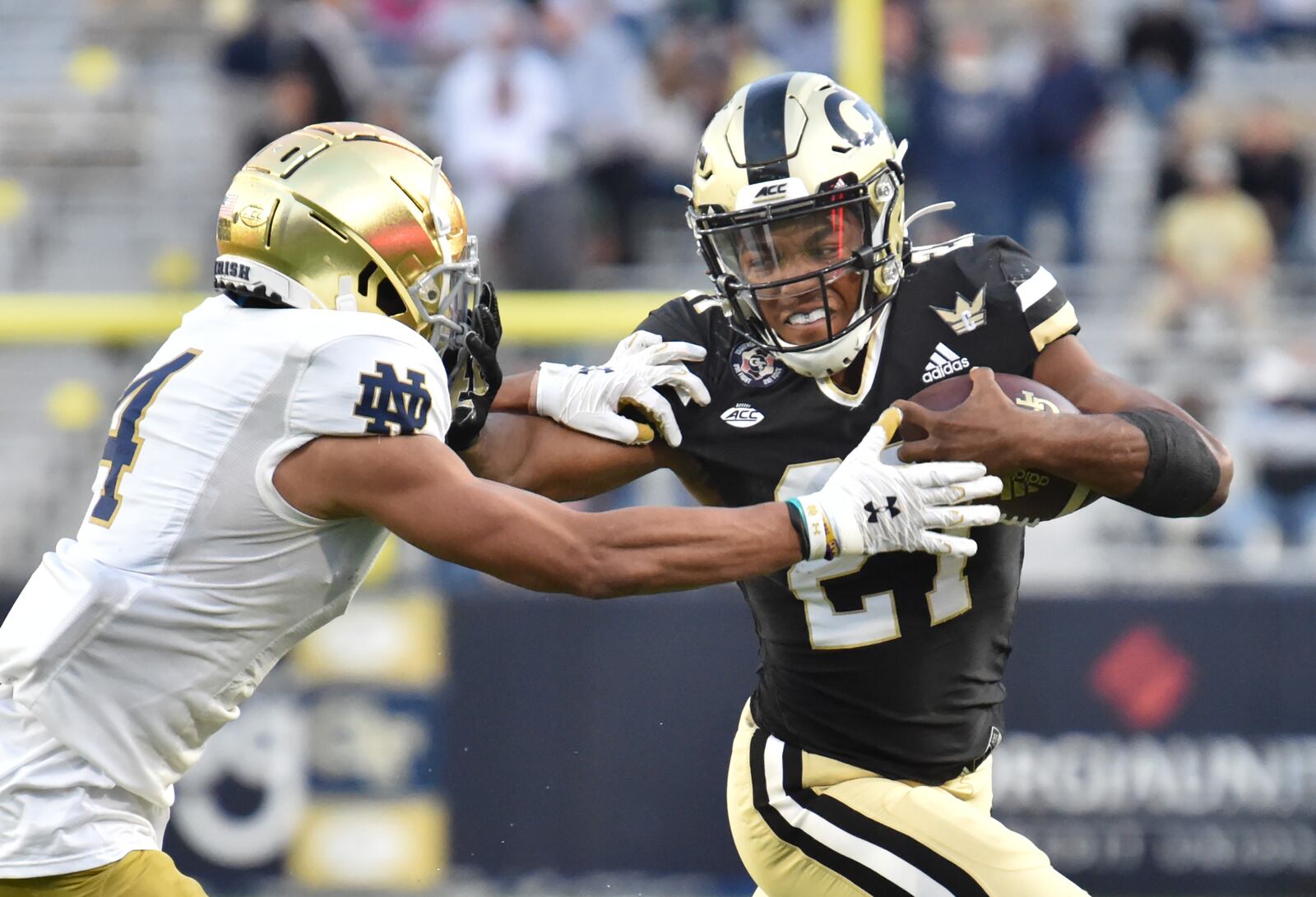 Georgia Tech's running back Jordan Mason (27) pushes Notre Dame's cornerback Nick McCloud (4). (Hyosub Shin / Hyosub.Shin@ajc.com)