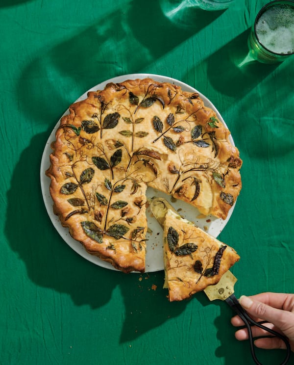 Pea Tendril Pressed Pie is essentially a double-crust quiche decorated with pea tendrils, herbs and edible flowers. (Courtesy of "Eat Your Flowers" / William Morrow)