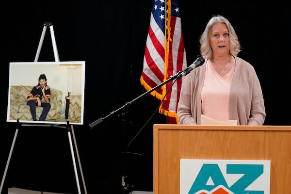 Karen Price sister of Ted Price (pictured off the left) speaks about the execution of Aaron Brian Gunches at the Arizona State Prison Wednesday, March 19, 2025 in Florence, Ariz. Gunches murdered Ted Price in 2002. (AP Photo/Darryl Webb)