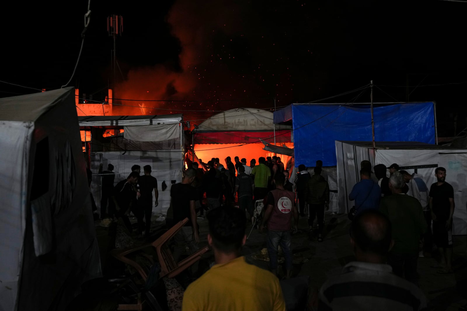 Palestinians react to a fire after an Israeli strike hit a tent area in the courtyard of Al Aqsa Martyrs hospital in Deir al Balah, Gaza Strip, Monday, Oct. 14, 2024. (AP Photo/Abdel Kareem Hana)