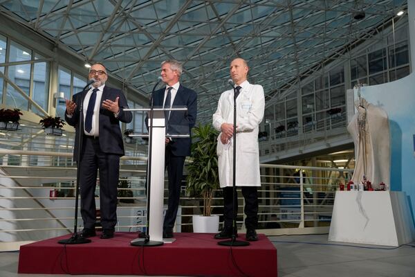 From left, head physician of Vatican's Health and Hygiene Office, Luigi Carbone, pope's spokeperson Matteo Bruni, and Surgeon Sergio Alfieri, speak to journalists, Saturday, March 22, 2025, in the entrance hall of Rome's Agostino Gemelli Polyclinic where Pope Francis is being treated for bilateral pneumonia since Feb. 14, 2025. (AP Photo/Gregorio Borgia)