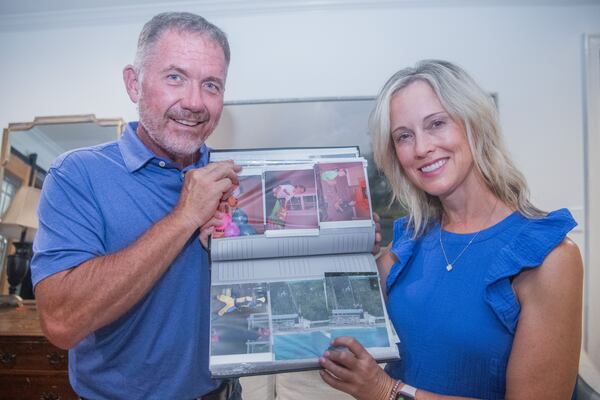 Charlton Tyler (left) and Laura Tyler show a photo album of Carson Tyler when he was a kid in their house in Moultrie on Wednesday, July 24, 2024.  (Ziyu Julian Zhu / AJC)