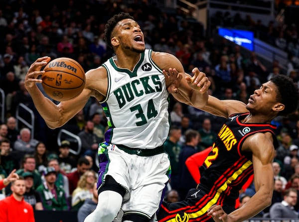 Milwaukee Bucks' Giannis Antetokounmpo (34) drives against Atlanta Hawks' De'Andre Hunter during an NBA basketball game Wednesday, March 9, 2022, in Milwaukee. (AP Photo/Jeffrey Phelps)