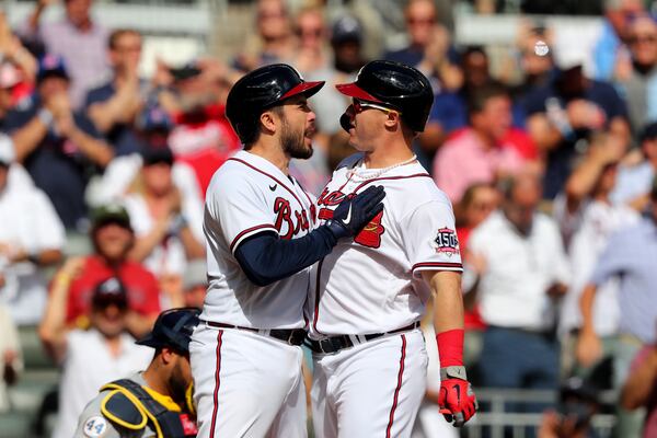 October 11, 2021 Atlanta: Atlanta Braves pinch hitter Joc Pederson reacts after hitting a three-run home run scoring  catcher Travis d'Arnaud, left, during the fifth inning against the Milwaukee Brewers in Game 3 of the NLDS on Monday, October, 11, 2021, in Atlanta. Curtis Compton / Curtis.Compton@ajc.com